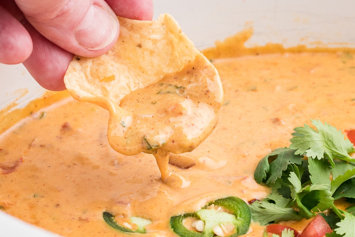 chip dipping in smoked queso dip.