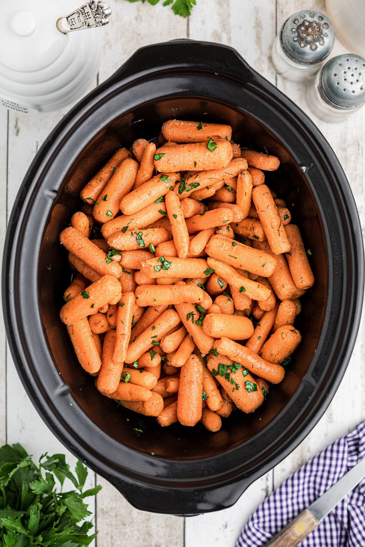 Long image of baby carrots in the crockpot.