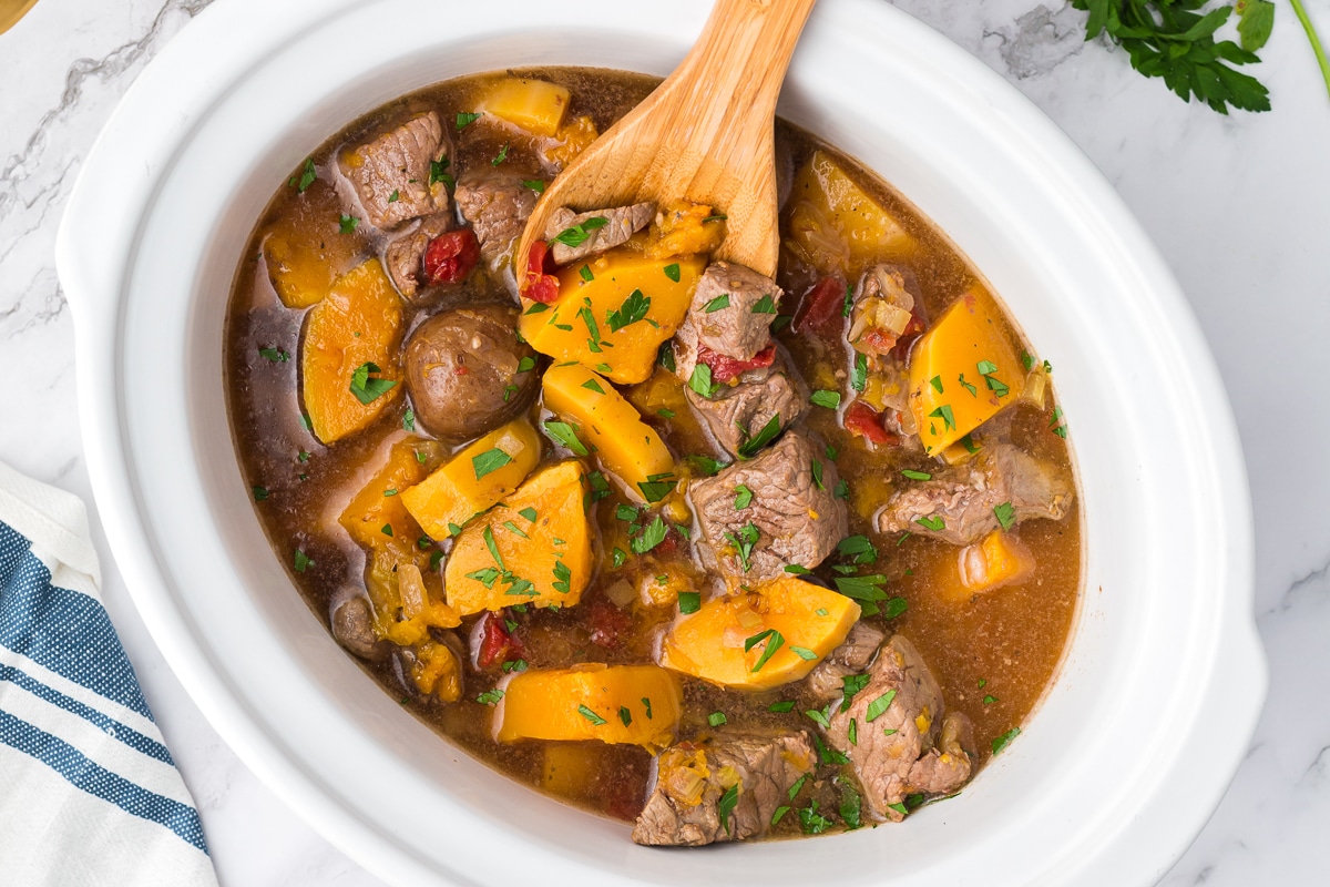 overhead shot of butternut squash beef stew in crockpot.