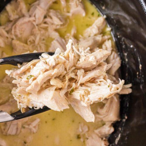 caeser chicken being held by thongs.