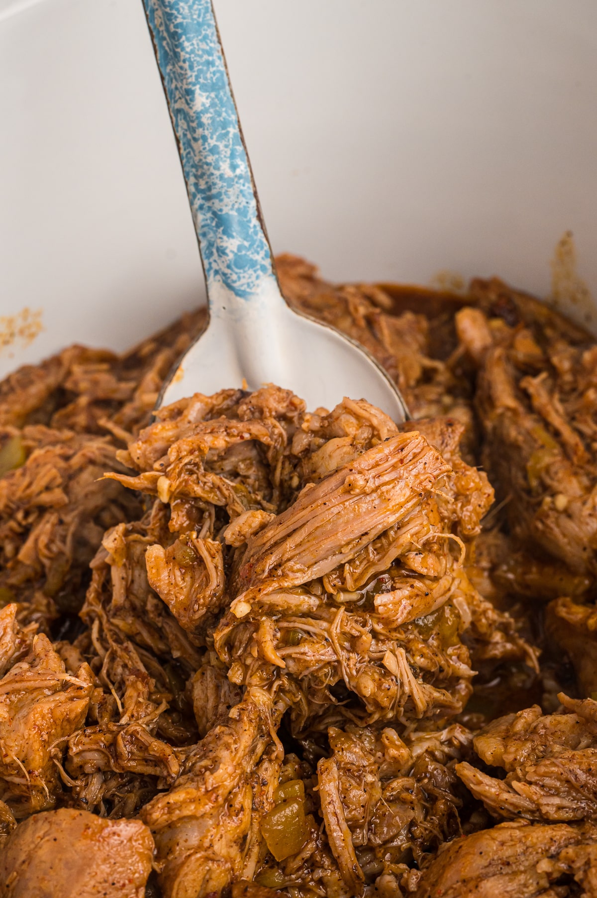spoon of cafe rio pork in slow cooker.