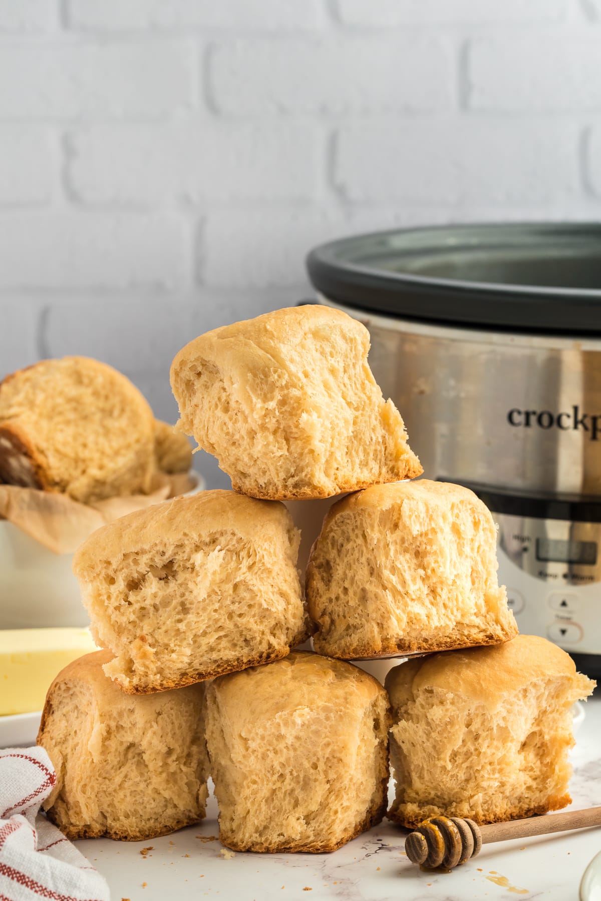 Stack of honey butter rolls on a plate.