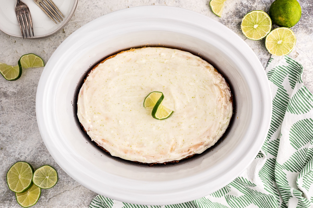 Done cooking key lime cake in slow cooker with glaze and lime.