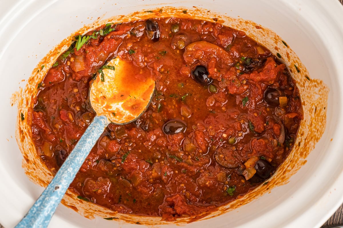 Overhead shot of puttanesca sauce in the crockpot.