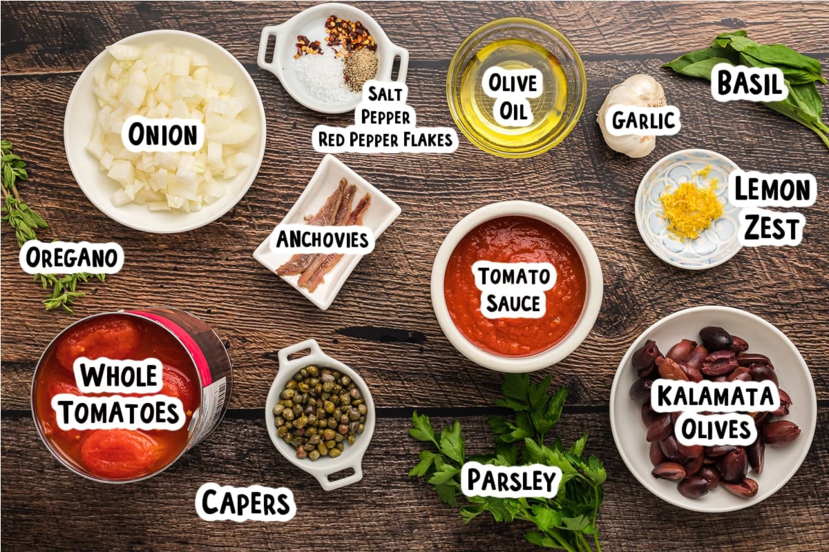 Ingredients for puttanesca sauce on a table.