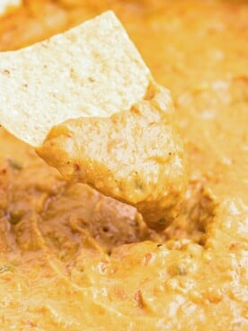 Chip dipping into bean dip.