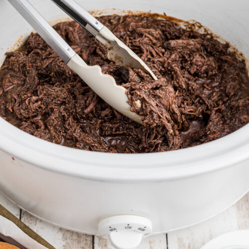 side view of barbecue venion roast in the slow cooker.