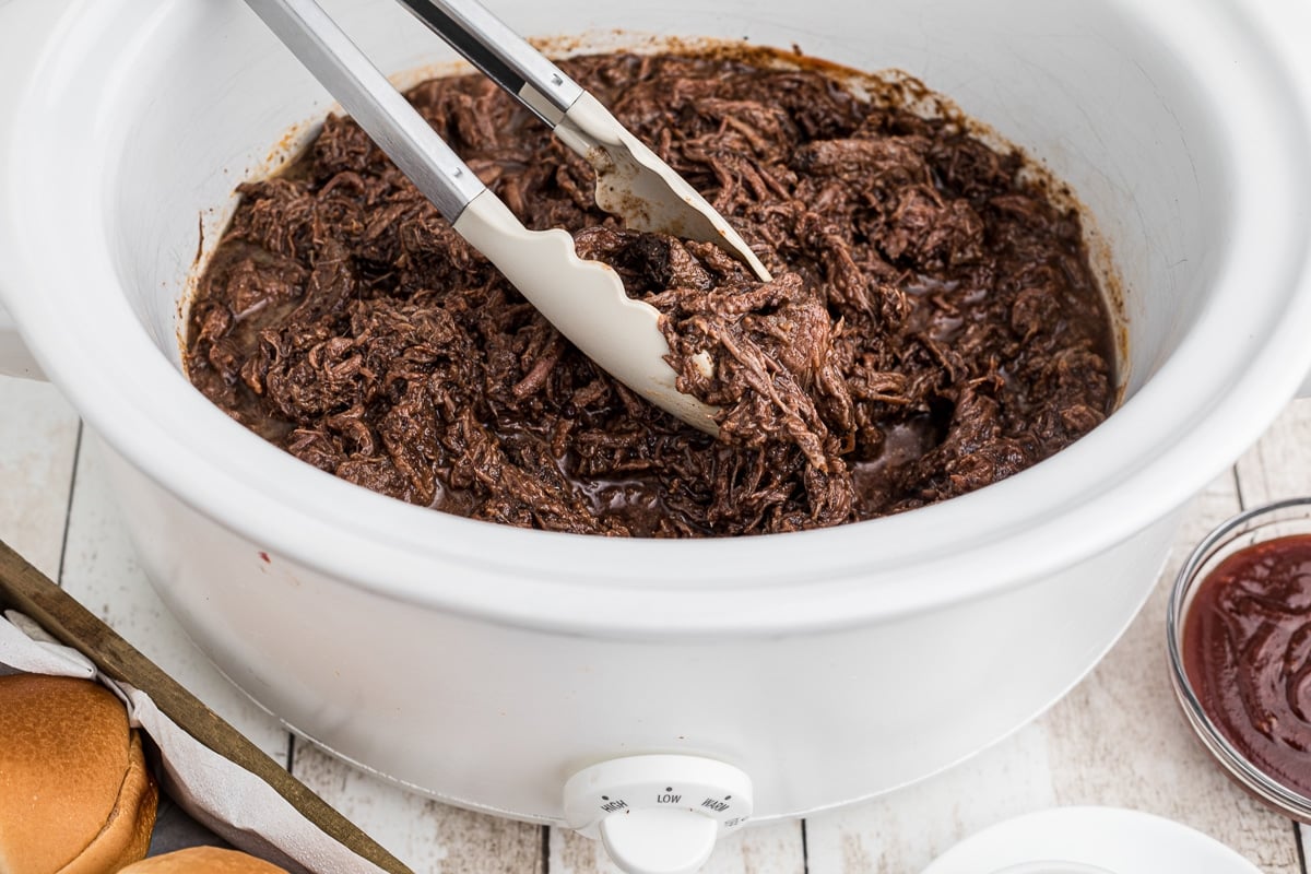 side view of barbecue venion roast in the slow cooker.