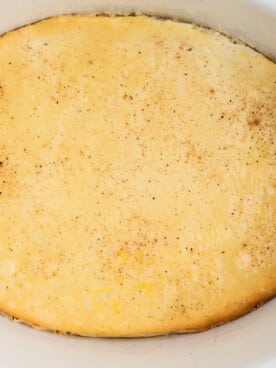 Close up of baked custard in a white crockpot.