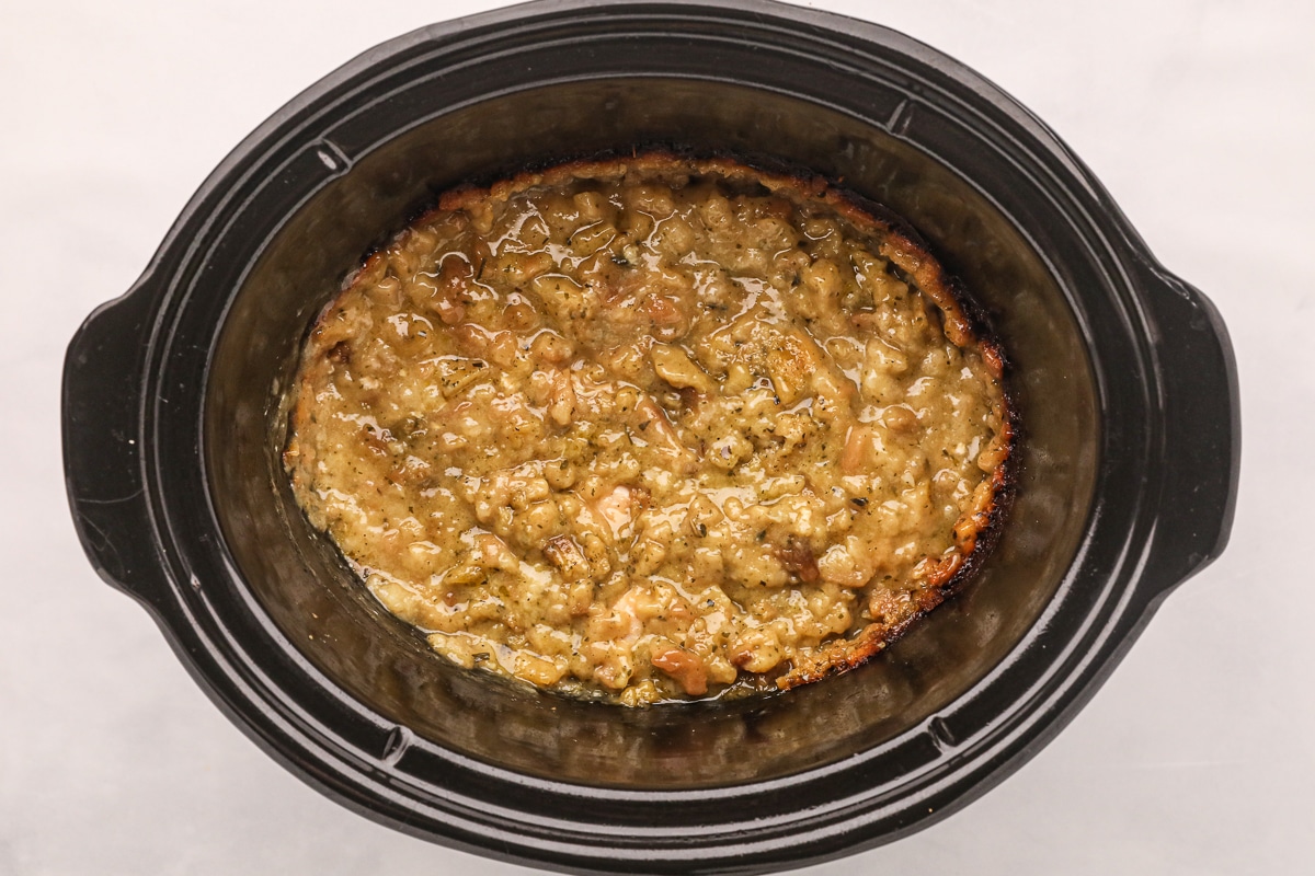 Cooked chicken and stuffing in crockpot.