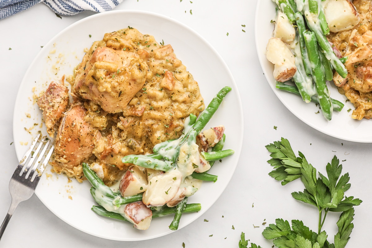 overhead shot of chicken, stuffing and green beans on a plate.