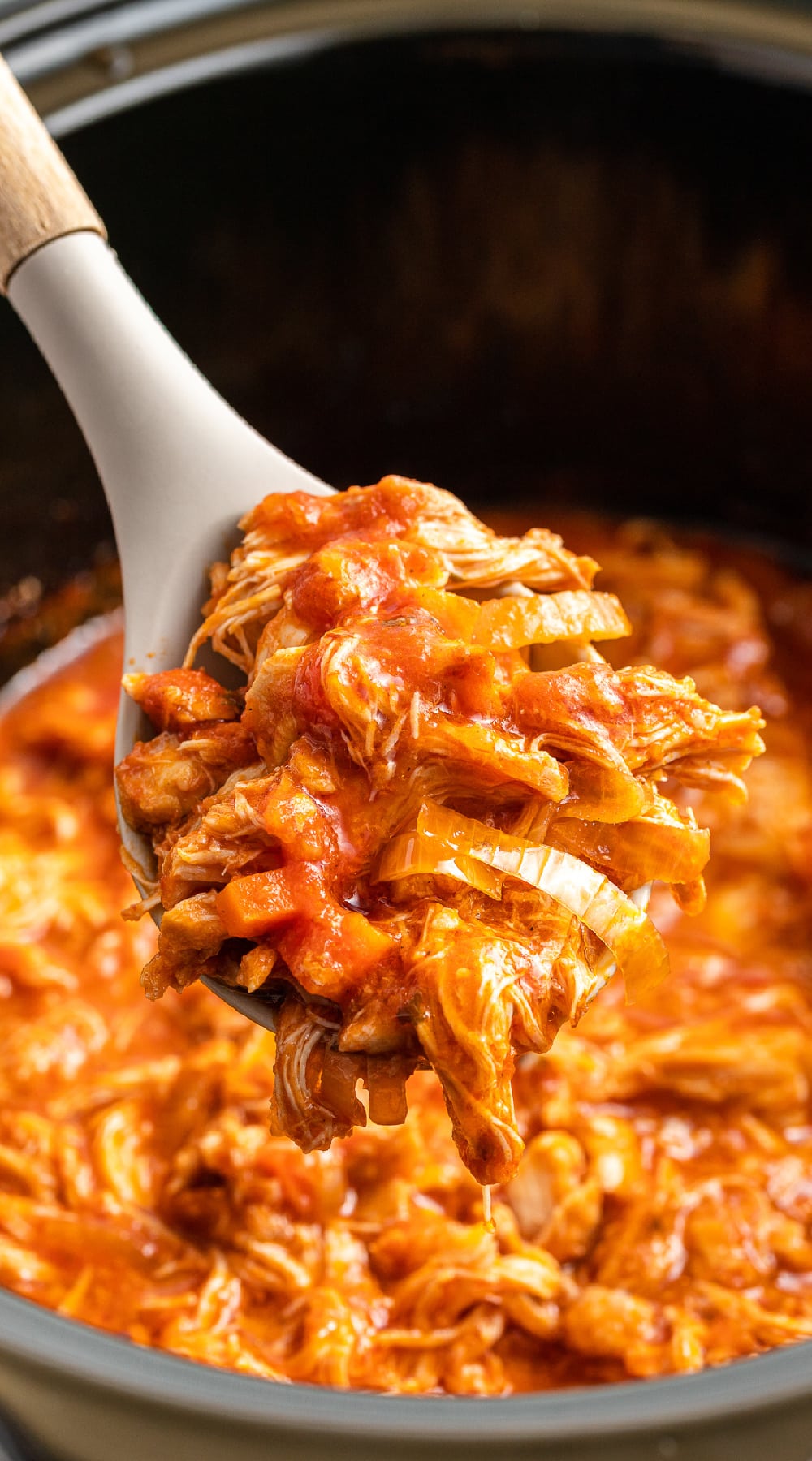 close of of chicken in marinara sauce on a spoon.