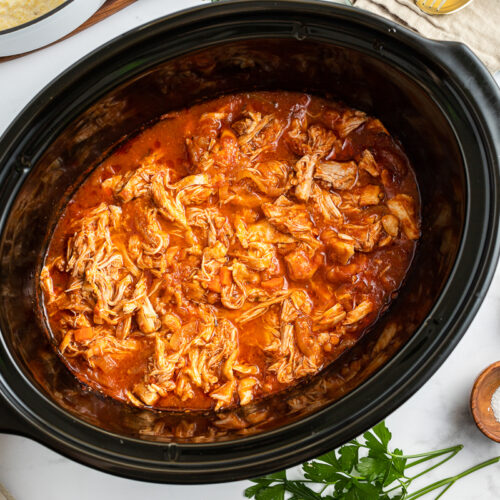 shredded chicken marinara in a slow cooker.