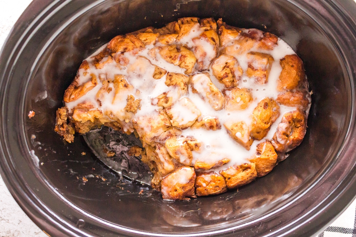 scoop taken out of cinnamon roll casserole.