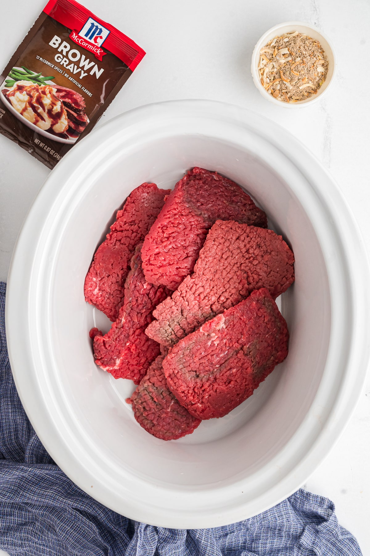 raw cube steak in a slow cooker.