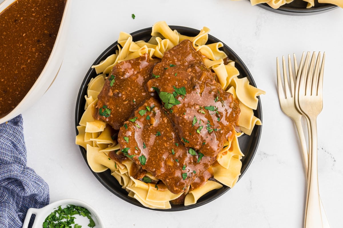 Cube steak on egg noodles.