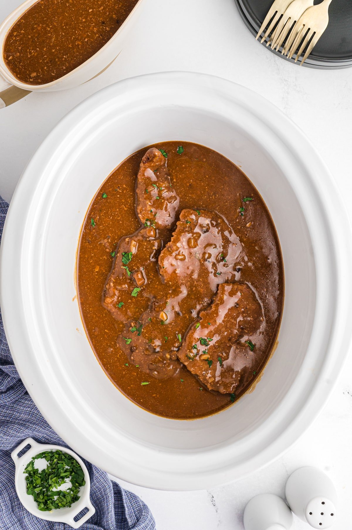 cooked cube steak in a crockpot.