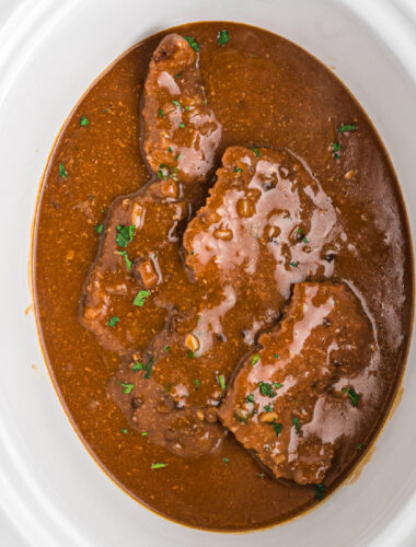 Cooked cube steak in a crockpot.