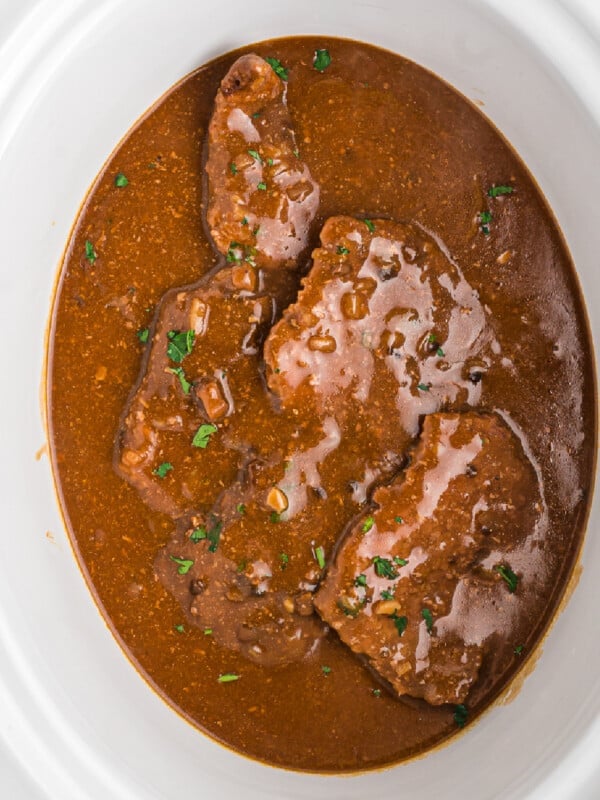 Cooked cube steak in a crockpot.