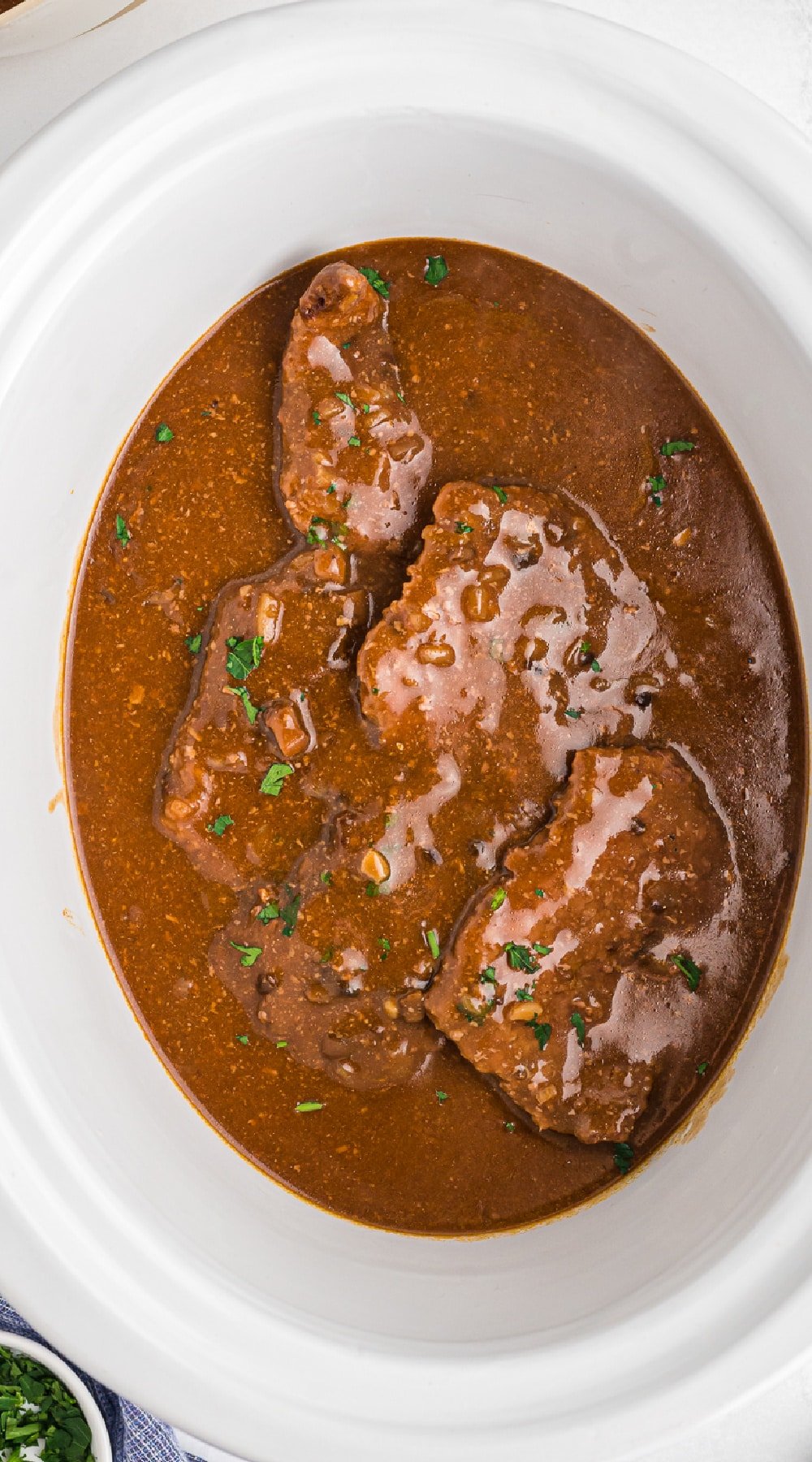 Cooked cube steak in a crockpot.