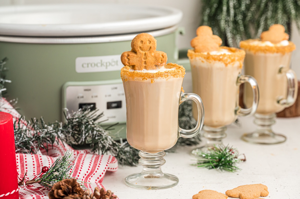 3 gingerbread lattes in mugs in front of slow cooker.