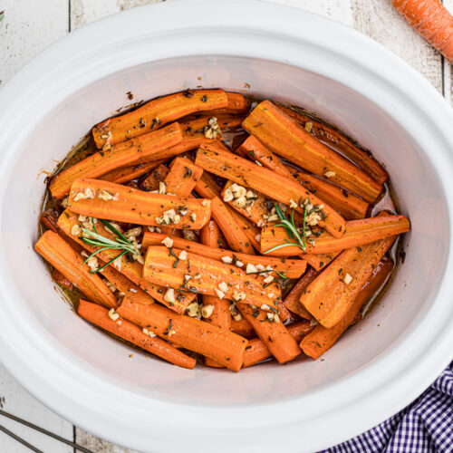 overhead shot of honey garlic carrots with rosemary on top.