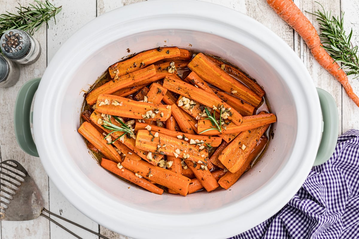 overhead shot of honey garlic carrots with rosemary on top.