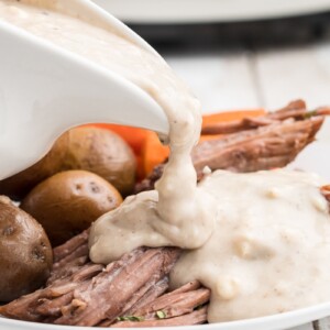 blue cheese being poured over pot roast.