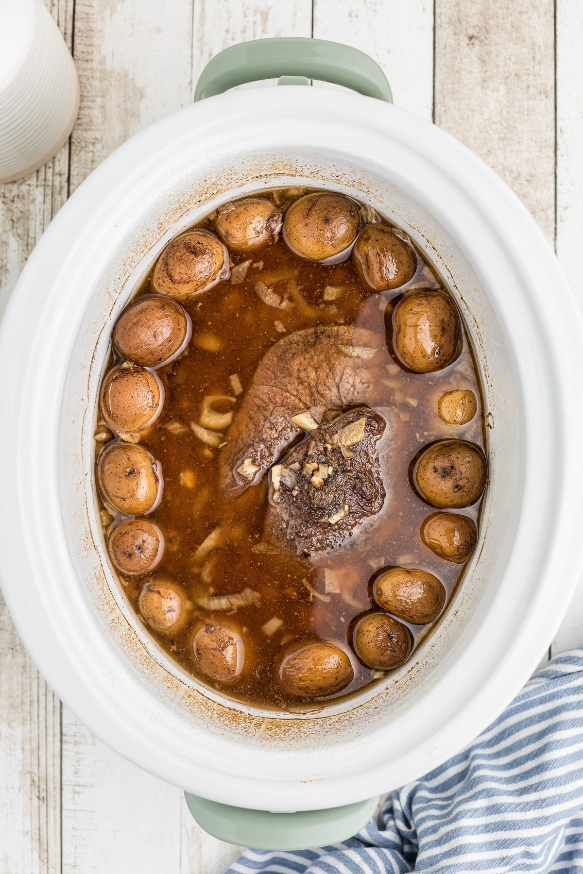 done cooking pot roast with vegeatbles in a slow cooker.