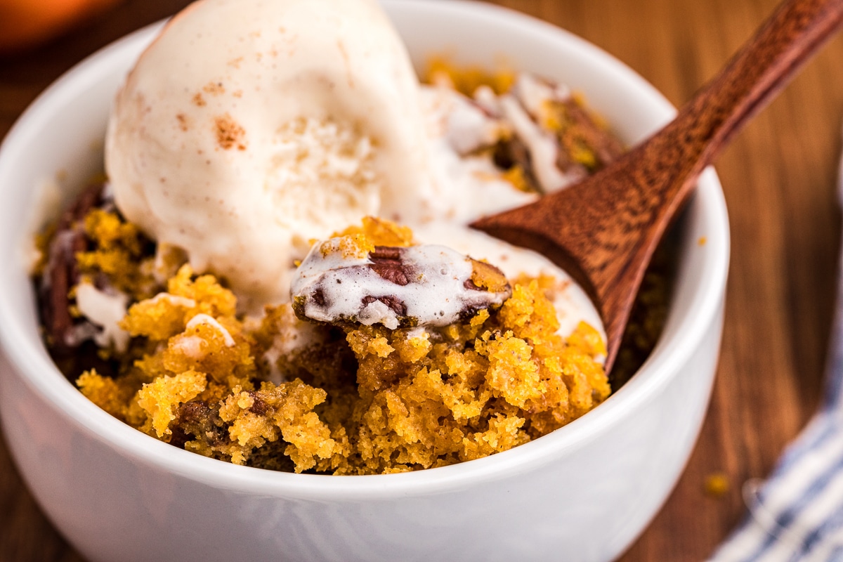 pumpkin cake in bowl with ice cream on top.