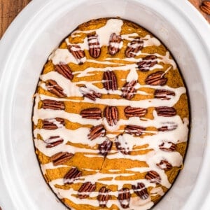 pumpkin cake in slow cooker with glaze on top.