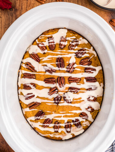 pumpkin cake in slow cooker with glaze on top.