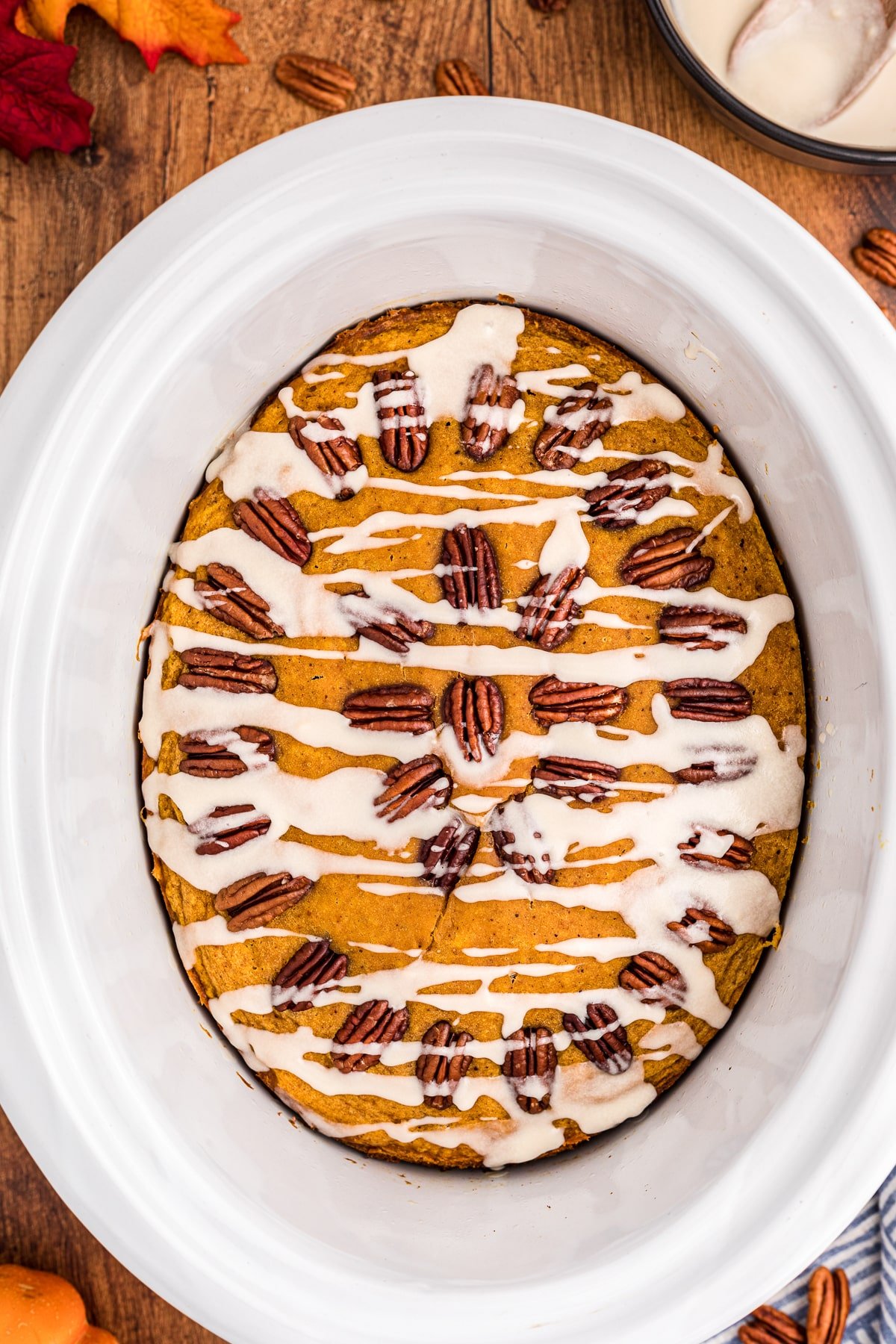 pumpkin cake in slow cooker with glaze on top.