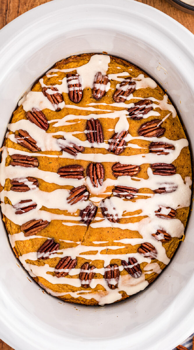 Long image of pumpkin cake in white crockpot.