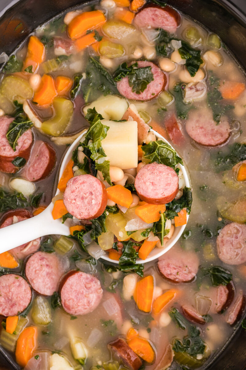 close up of sausage and white bean soup in slow cooker.