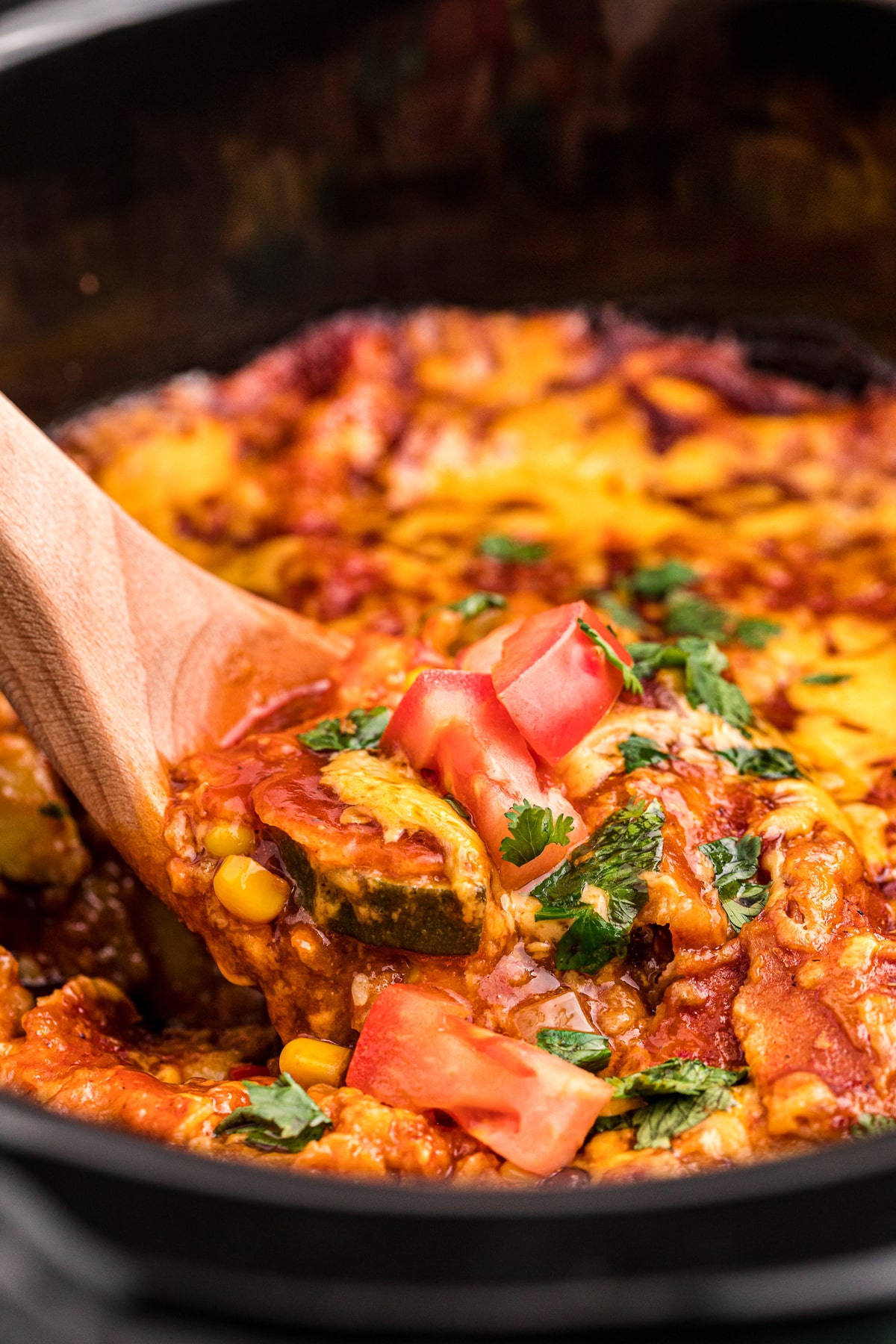 close up of vegetarian enchiladas on a spoon.