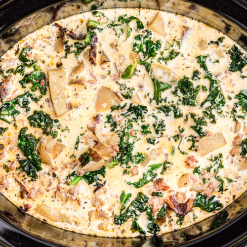 Close up of zuppa toscana in a black crockpot.