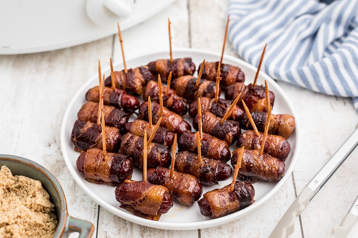 cooked bacon wrapped smokies on a plate.
