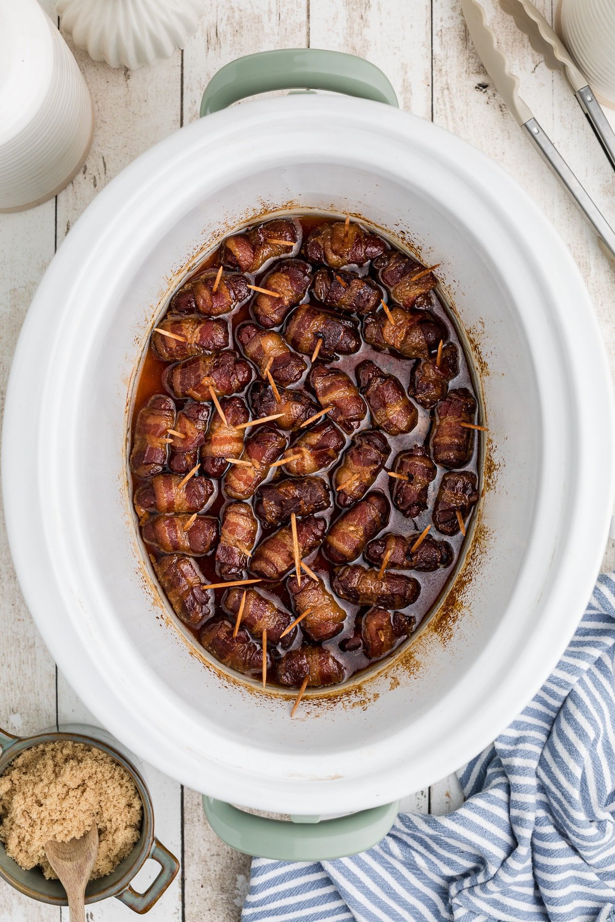 Cooked bacon wrapped smokies in a slow cooker.