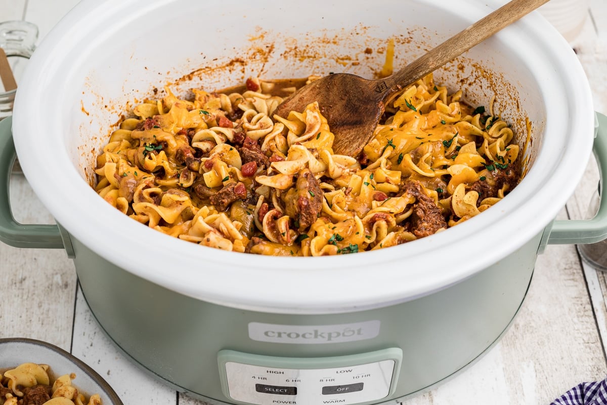 Side view of beef noodle casserole with spoon in it.