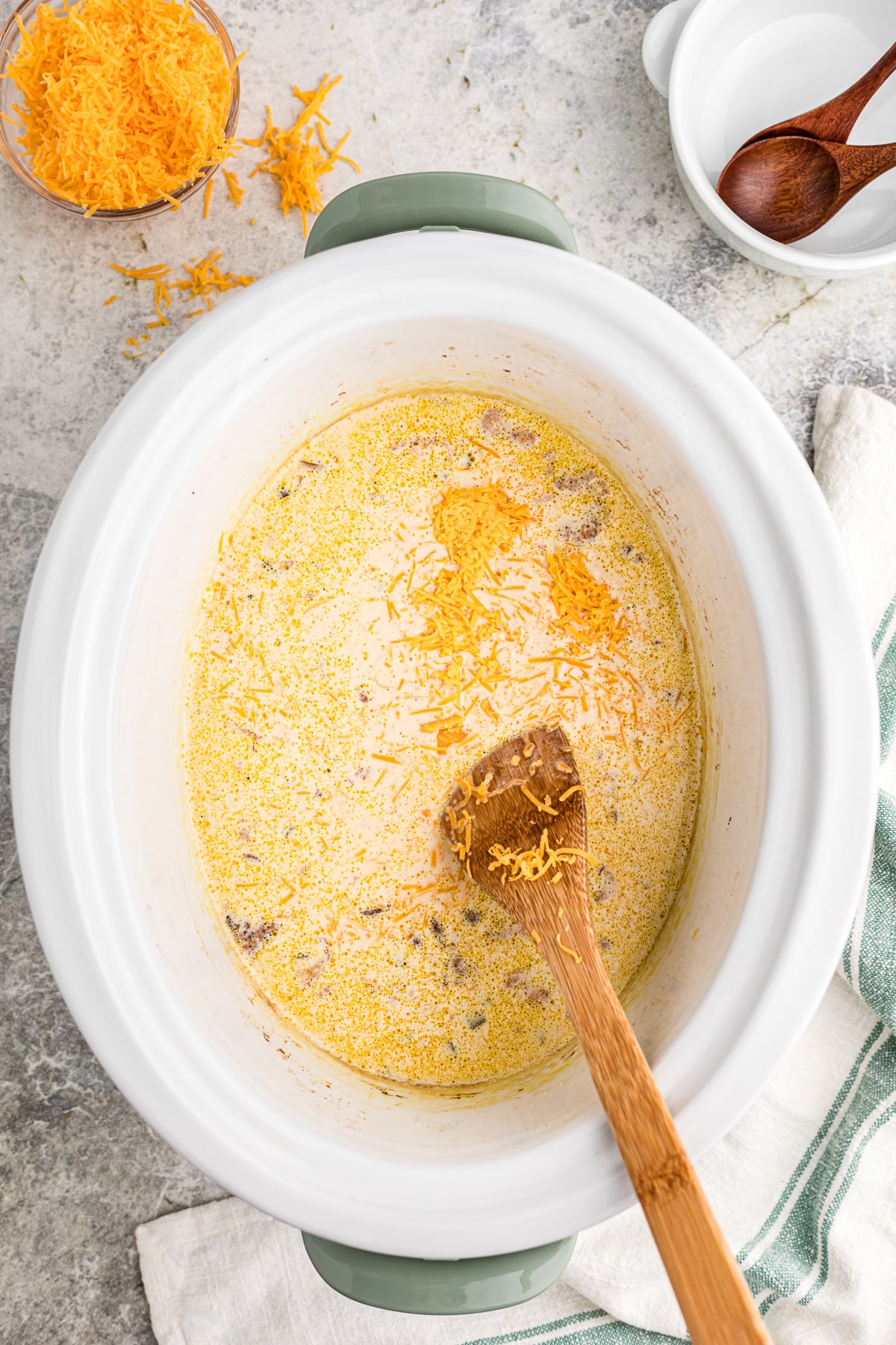 cheese added to the beer cheese soup in a crockpot.