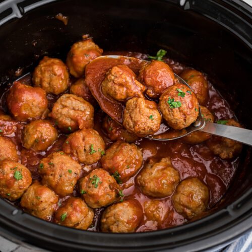 Cooked beer meatballs in a slow cooker.