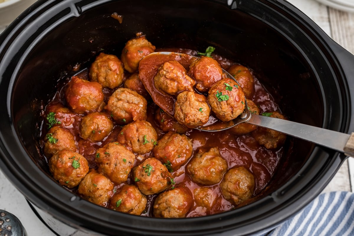 Cooked beer meatballs in a slow cooker.