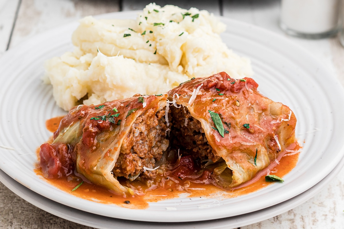 plate with a sliced open cabbage roll.