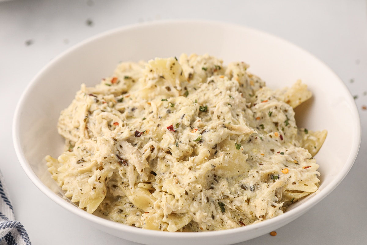 bowl of creamy pesto chicken pasta.