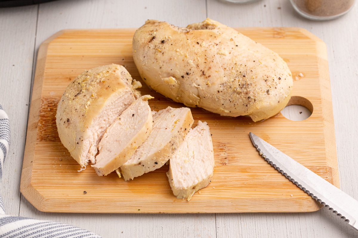 2 chicken breasts on a cutting board.