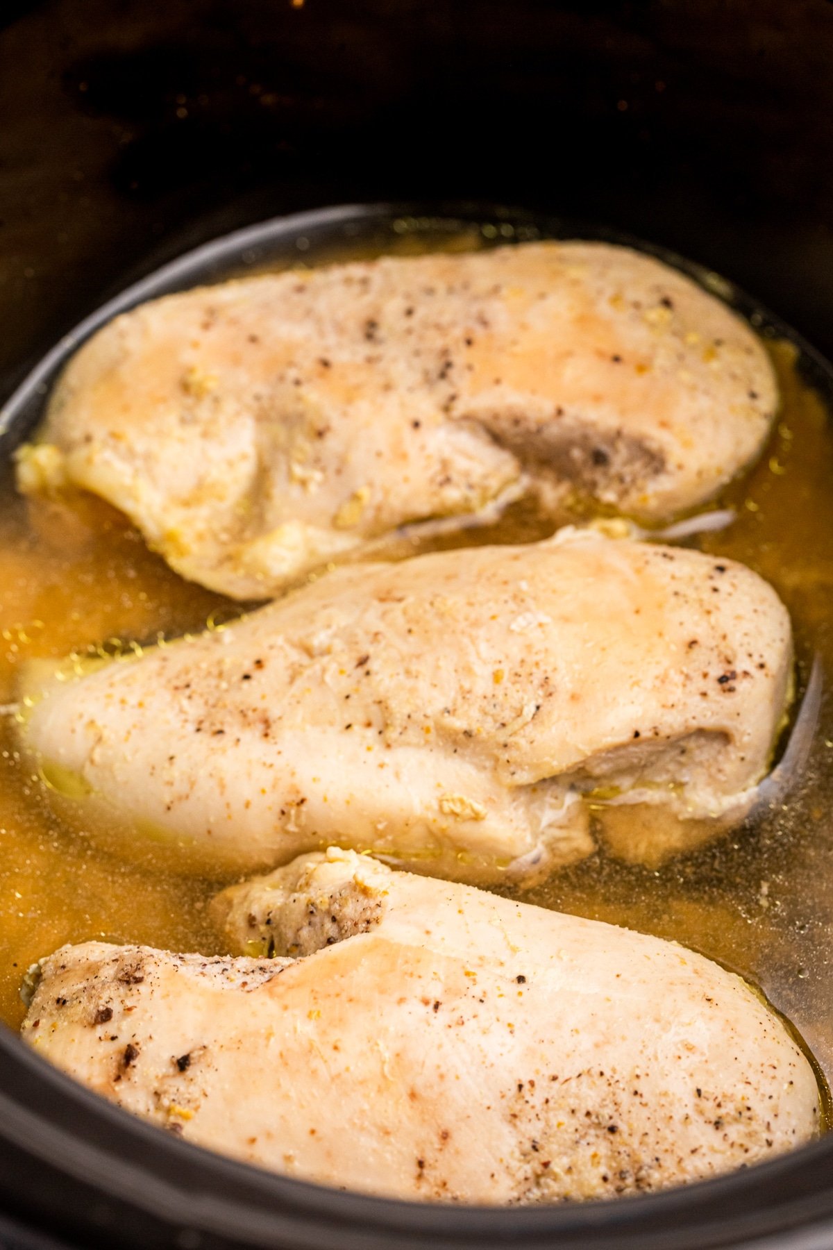 Chicken breasts cooked in a crockpot.
