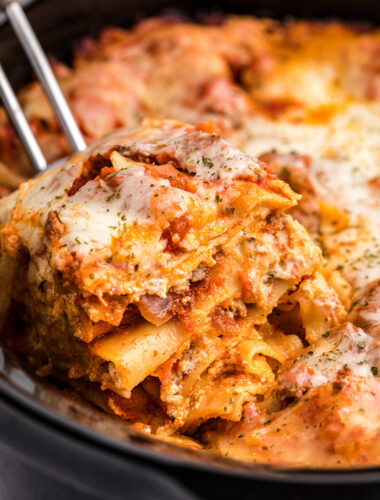 Lasagna on on spatula coming from crockpot.