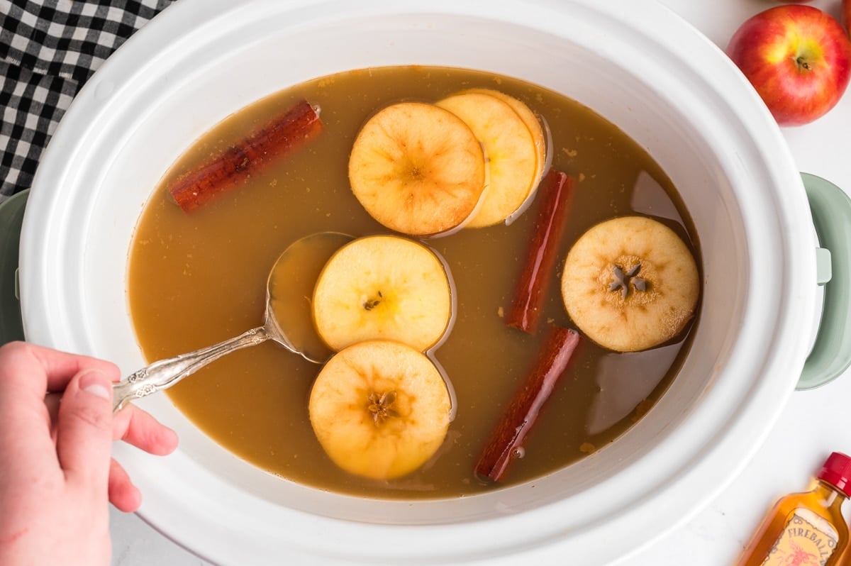 cooked fireball caramel apple cider in slow cooker.