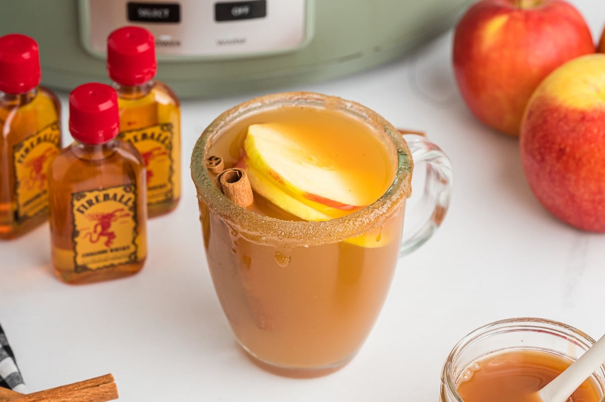 close up of whiskey cider in clear mug.